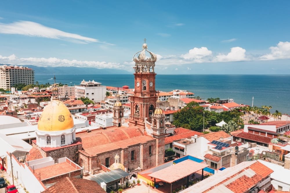 The church crown over the rooftops and the bay